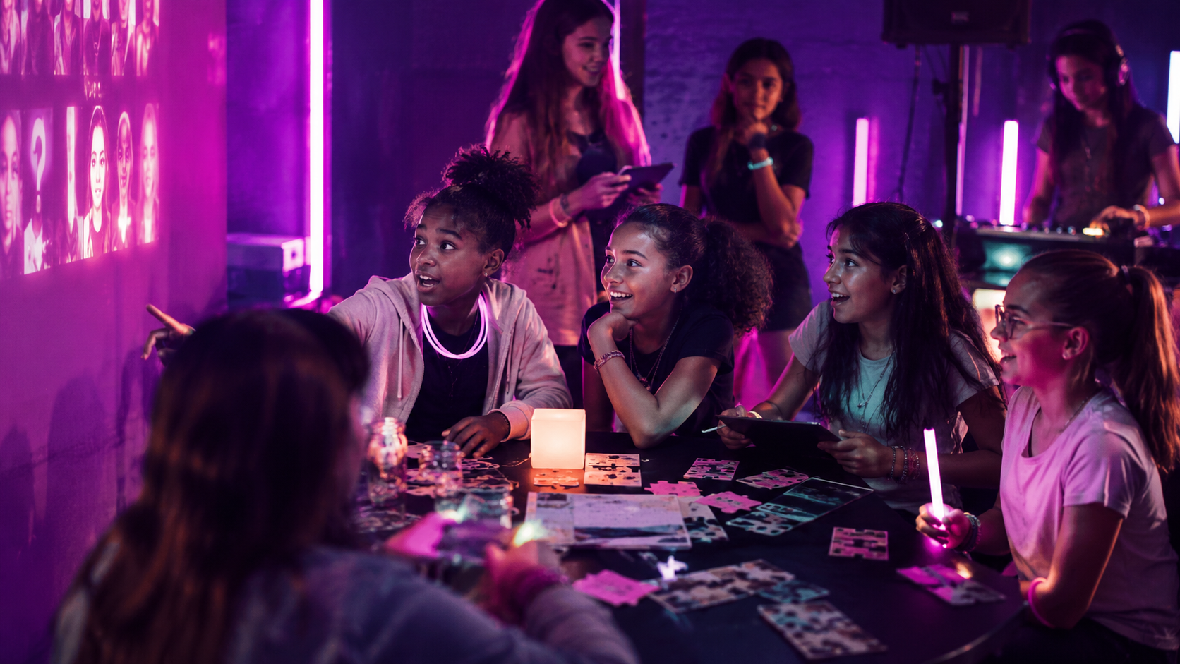 Girls reacting to a projected experience with glow sticks